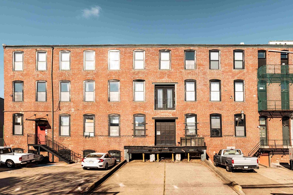 a large brick building with cars parked in front of it