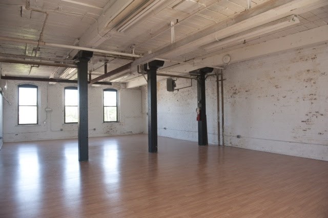 an empty room in a building with wood floors