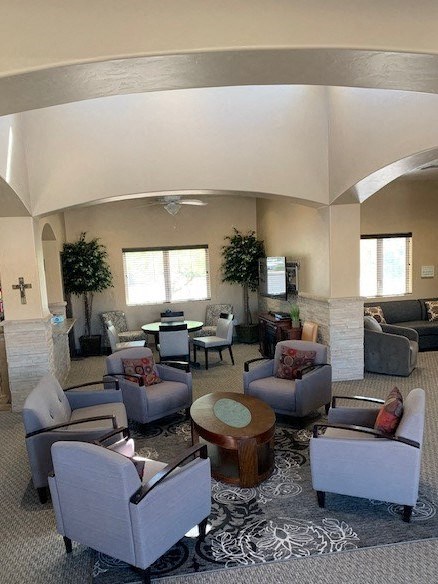 A living room with grey couches and a wooden coffee table.