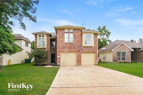 a large brick house with a garage and a driveway