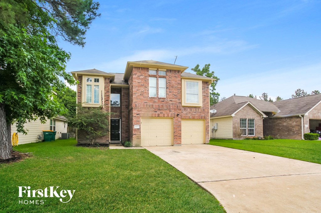 a house with a driveway and a lawn