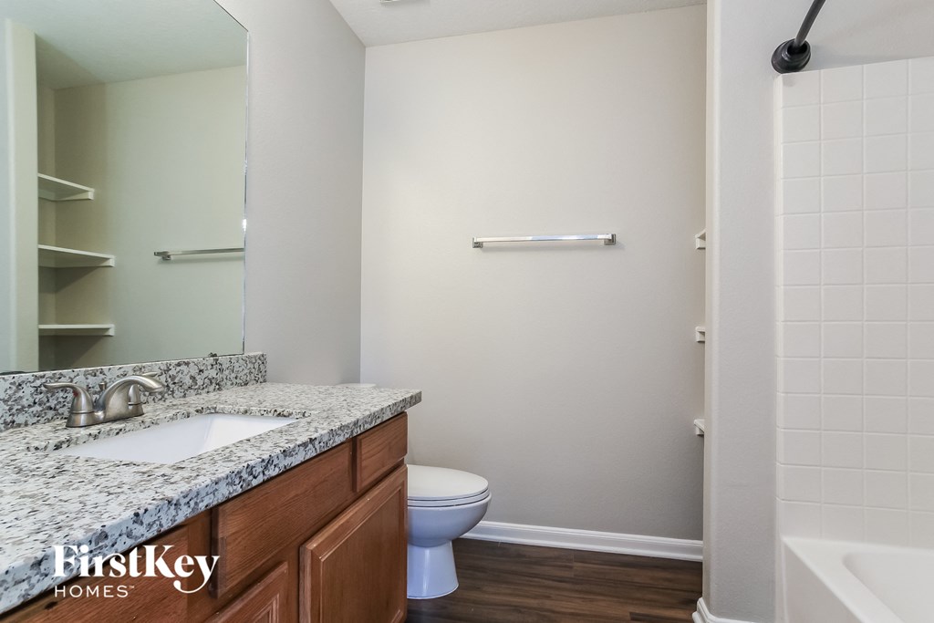 a bathroom with a toilet and a sink and a mirror