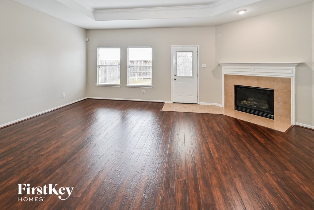 A room with wooden floors and a fireplace.