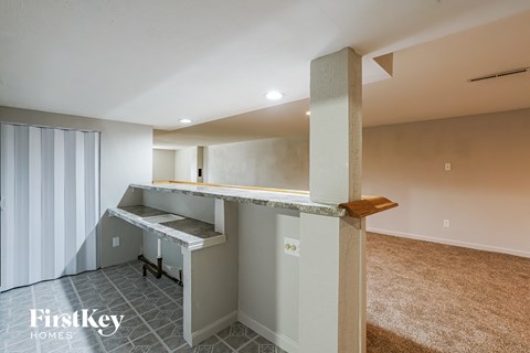 a kitchen with a counter top and a staircase in a house