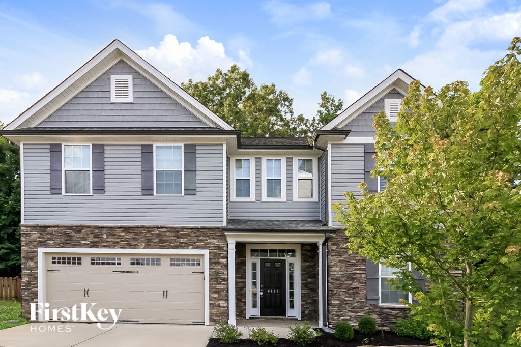a blue house with a white garage door