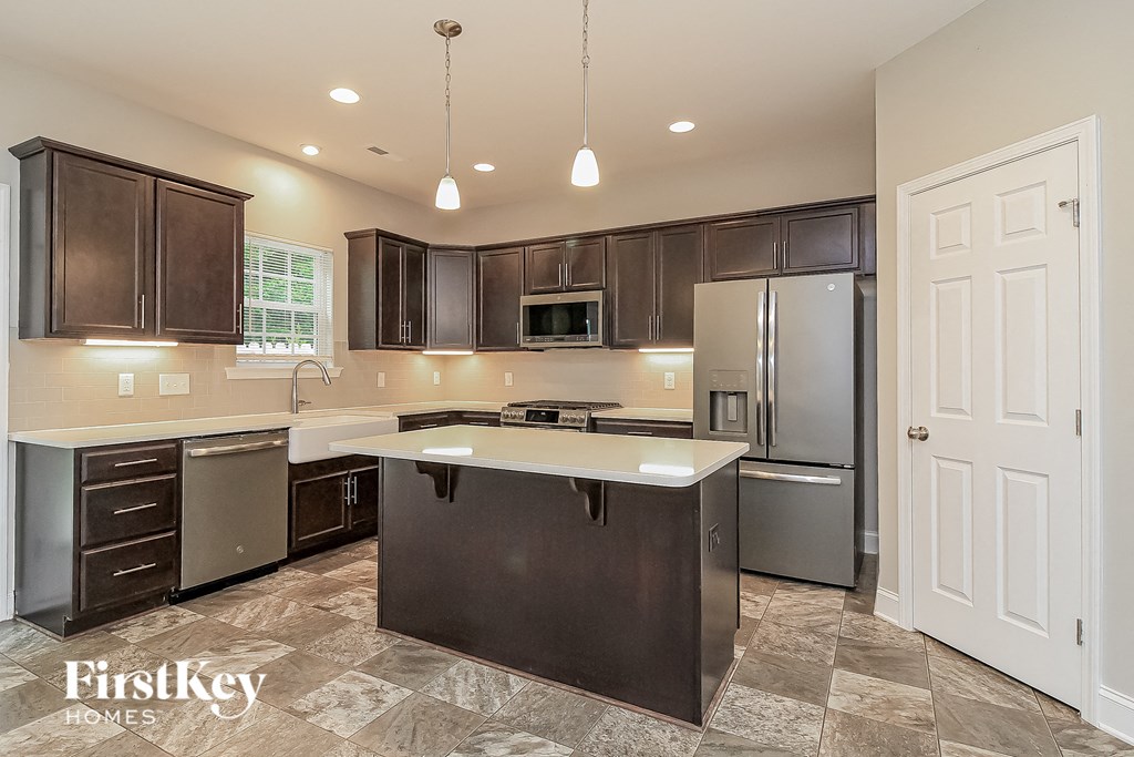 a kitchen with stainless steel appliances and a white counter top