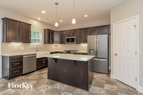 a kitchen with stainless steel appliances and a white counter top