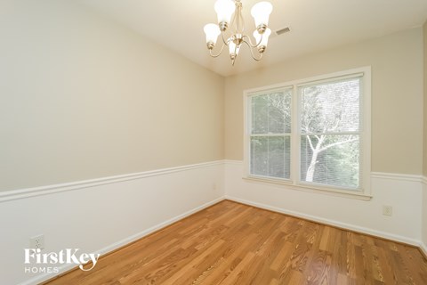 A room with wooden floors and a chandelier.