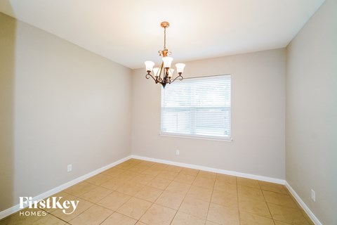 a dining room with a chandelier and a window