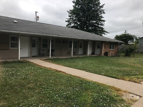a house with a sidewalk and a lawn