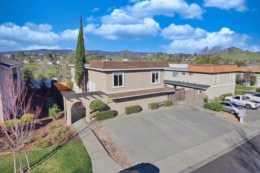 an aerial view of a house with a parking lot and a driveway