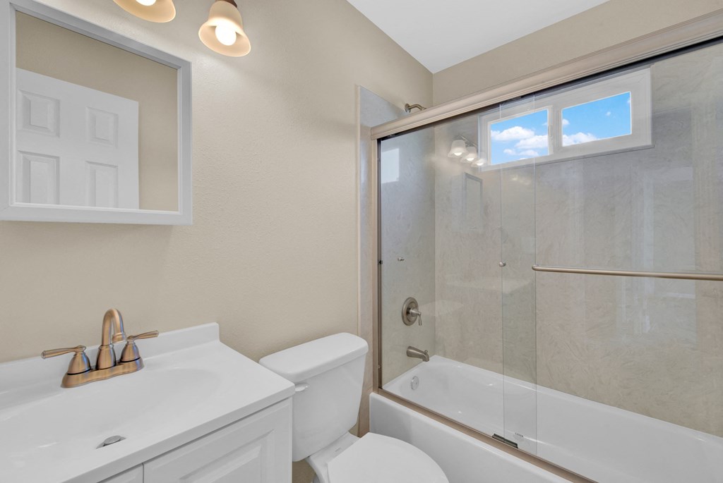 a bathroom with a sink toilet and a shower