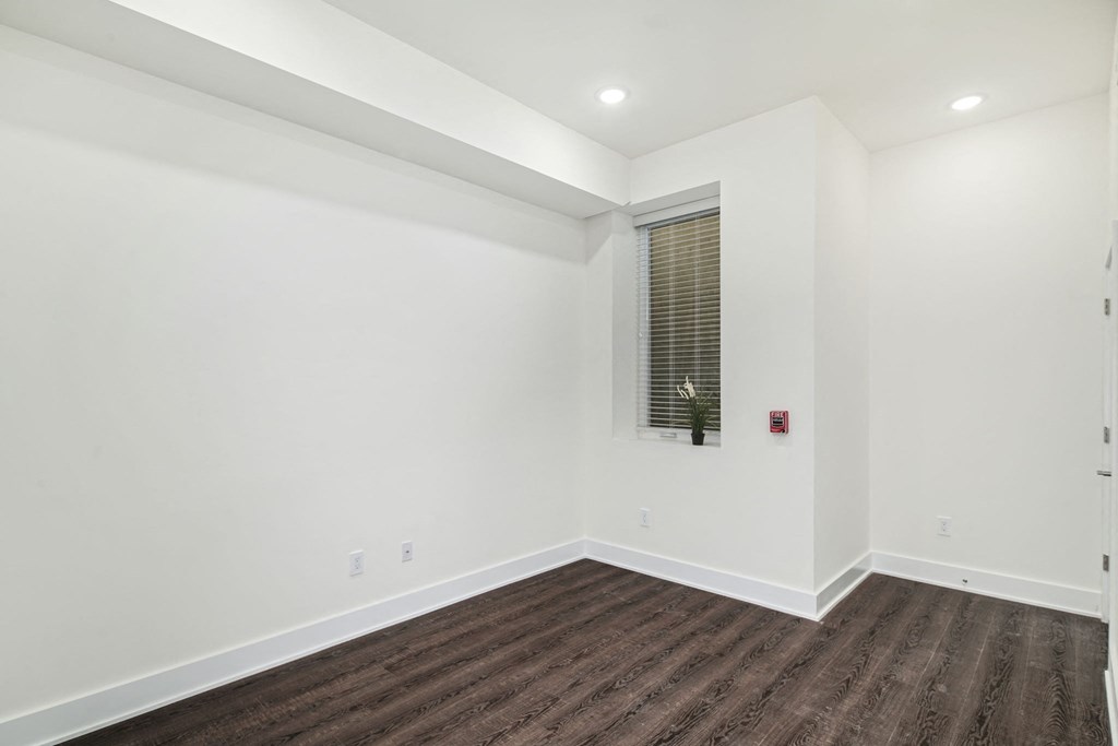 a living room with white walls and a window