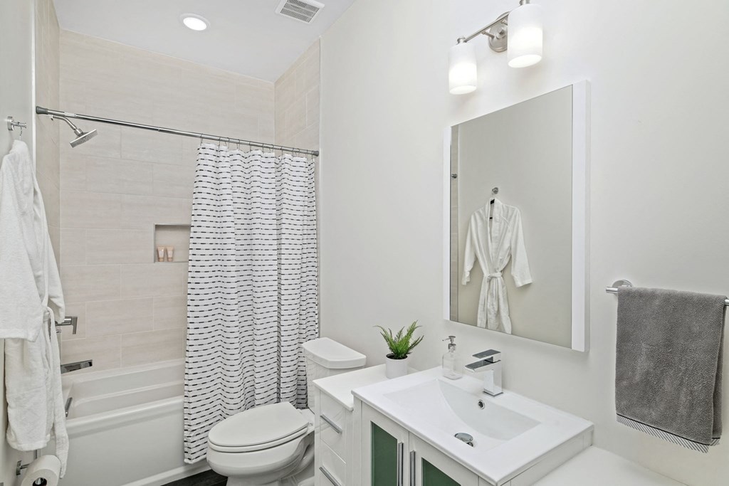 a bathroom with a sink toilet and a mirror
