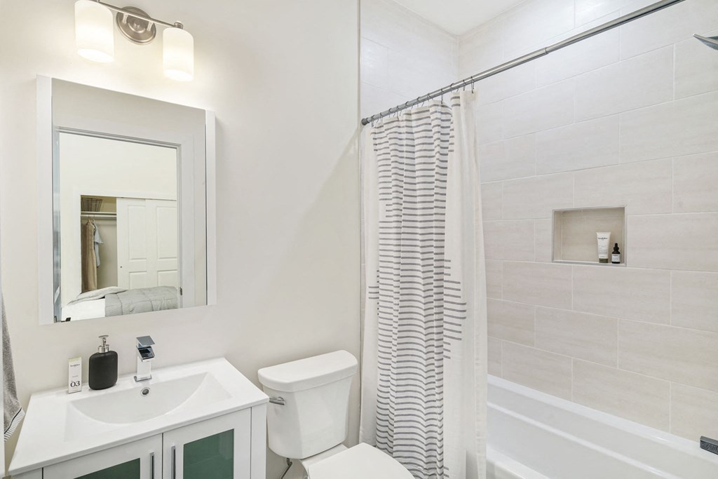 a bathroom with a shower and a sink and a toilet