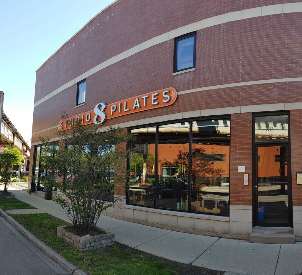 the exterior of a store with a brick building