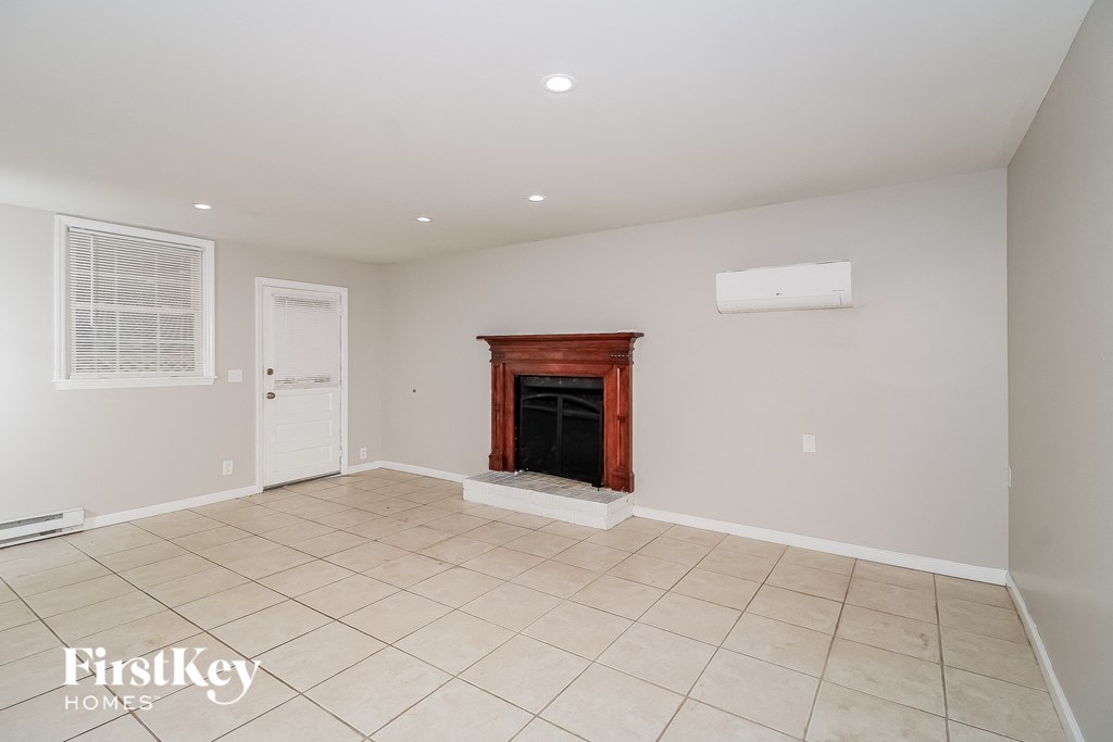 a living room with a fireplace and a tiled floor
