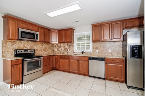 a kitchen with wooden cabinets and stainless steel appliances