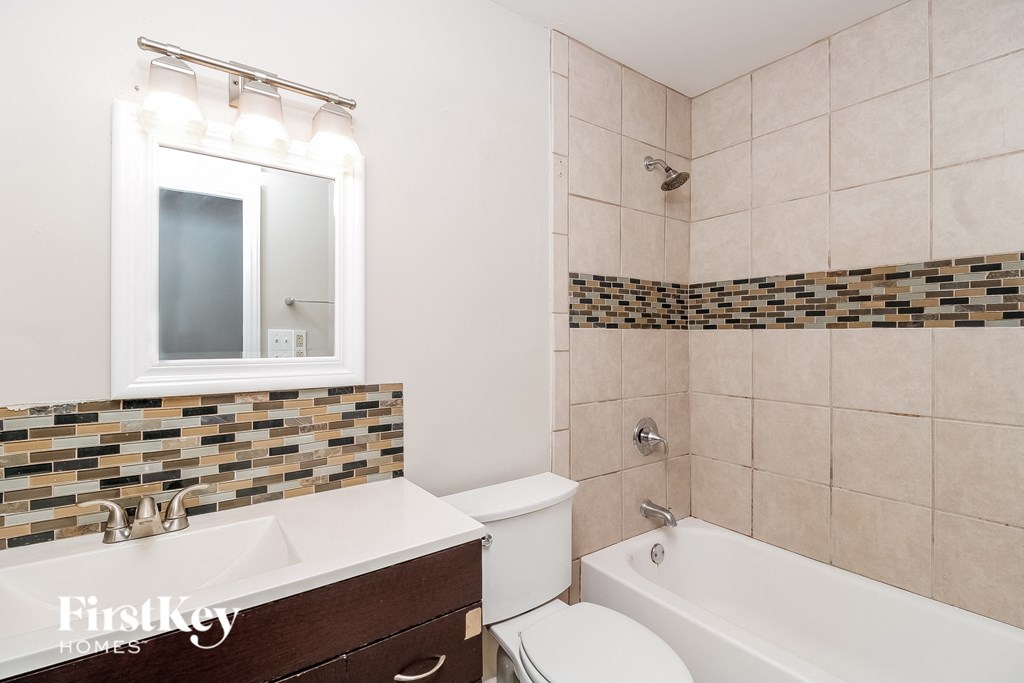 a bathroom with a sink toilet and a bath tub