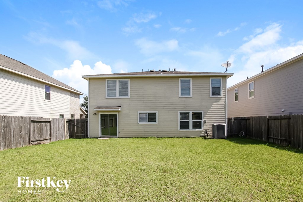 A house with a fence and a grassy yard is for sale.