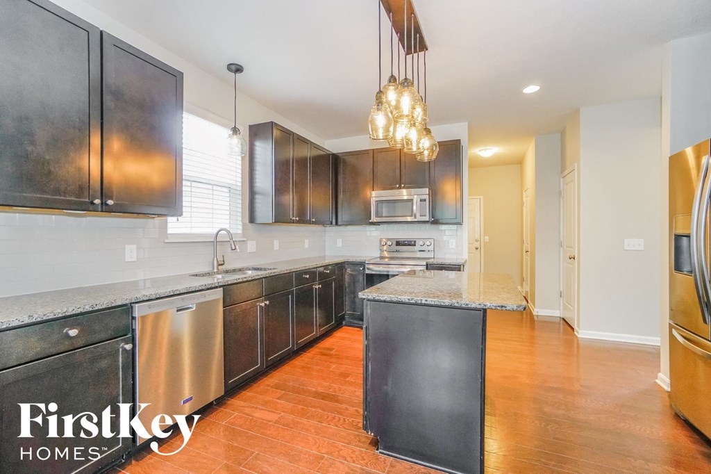 a kitchen with stainless steel appliances and wooden cabinets