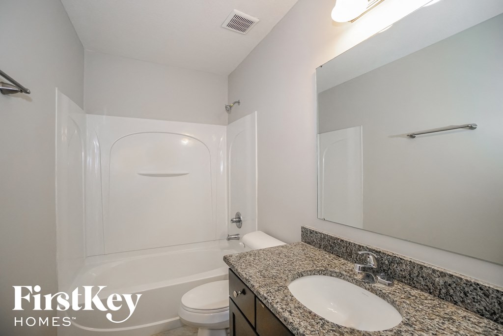 a bathroom with a sink and a toilet and a shower