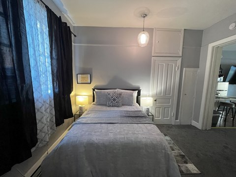 a small bedroom with a bed and a window