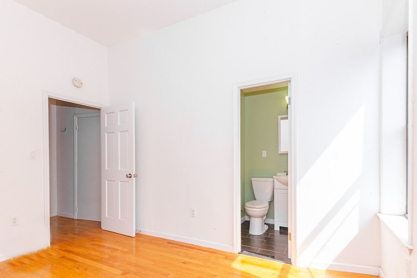 an empty room with a toilet and a door