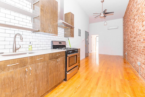 a kitchen with a stove top oven and a sink