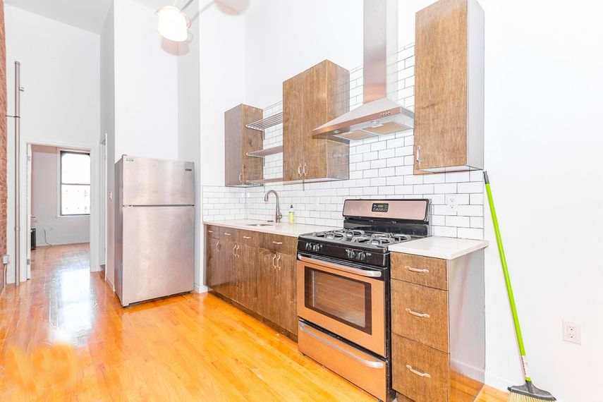 a kitchen with stainless steel appliances and wooden cabinets