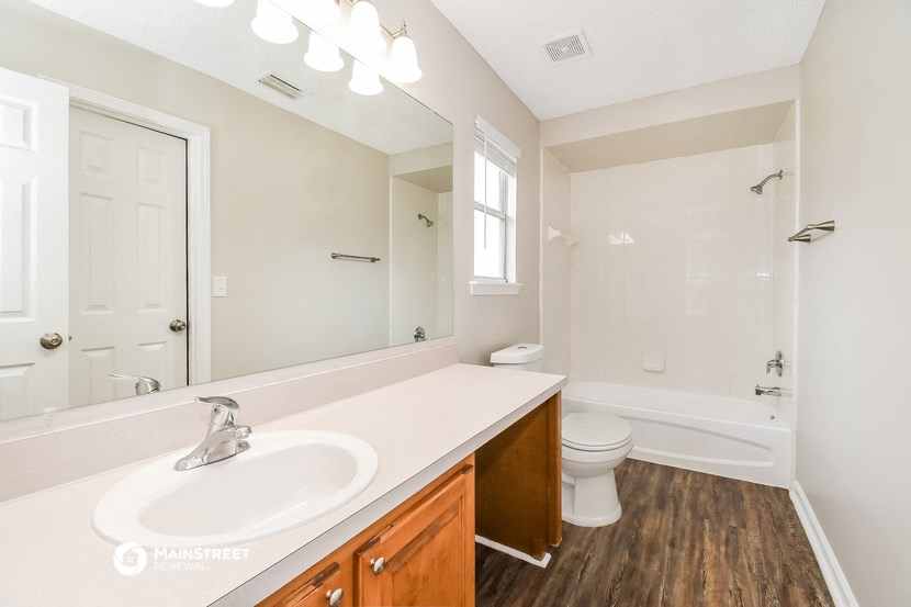 a bathroom with a sink and a toilet and a mirror