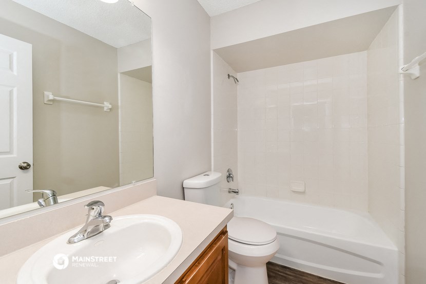 a bathroom with a sink and a toilet and a bath tub