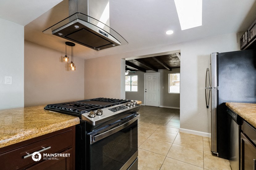 the kitchen has stainless steel appliances and granite counter tops
