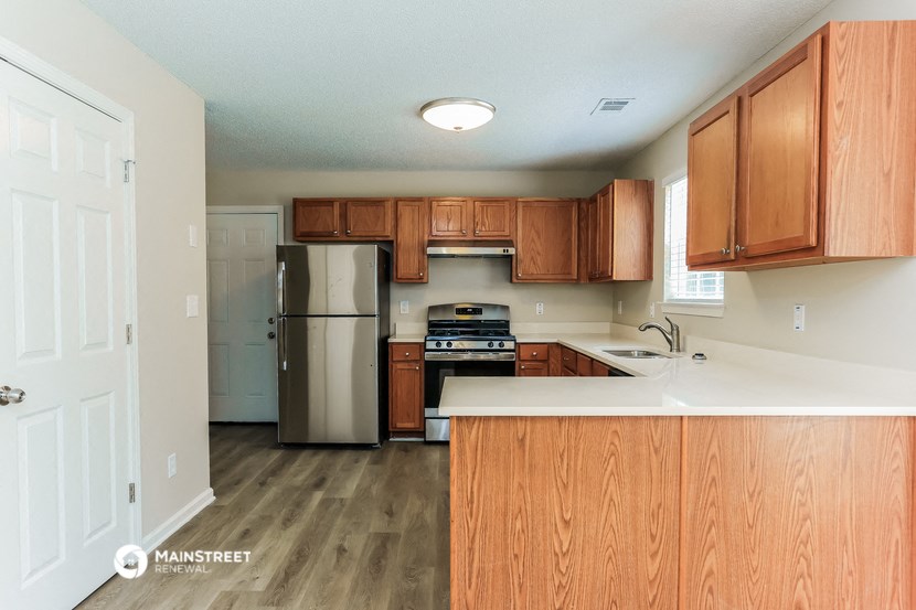 a kitchen with wooden cabinets and stainless steel appliances