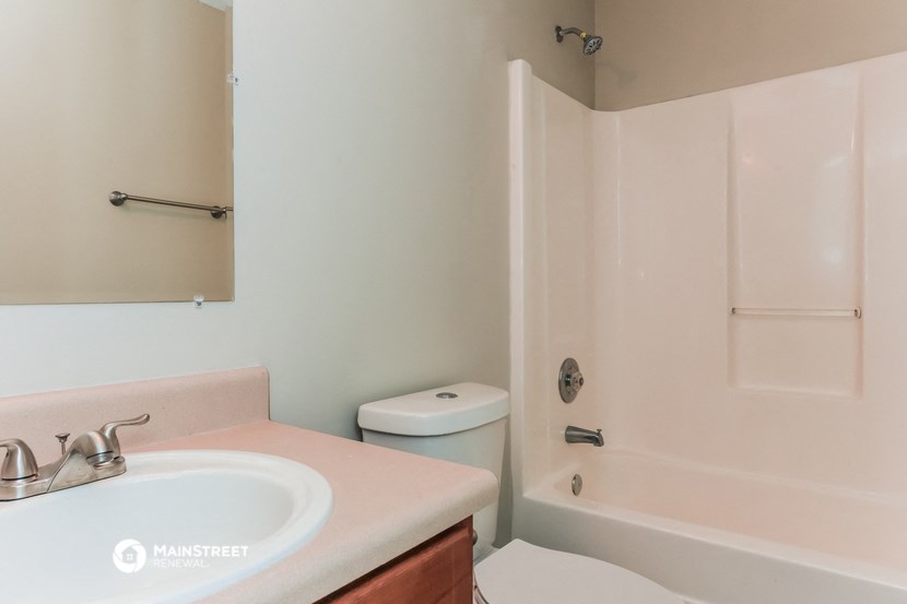 a bathroom with a sink and a shower and a toilet