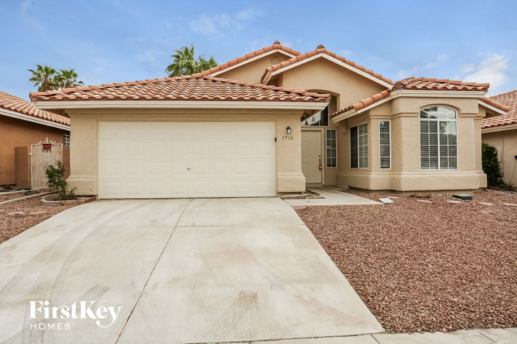 A house with a red tile roof and a garage door.
