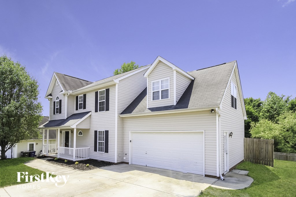 A two-story house with a garage is for sale.