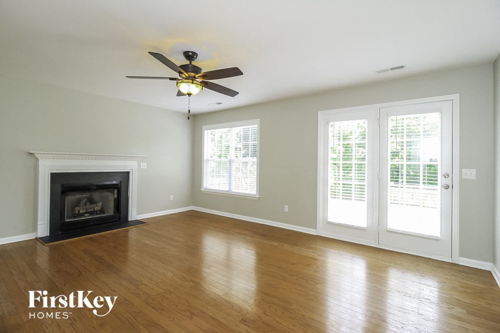 A room with a fireplace and a ceiling fan.