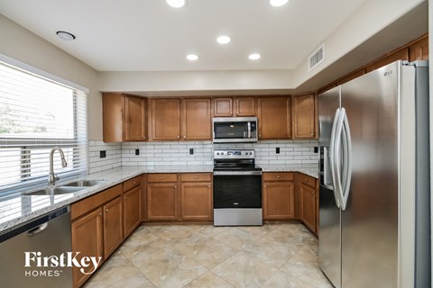 A kitchen with wooden cabinets and stainless steel appliances.