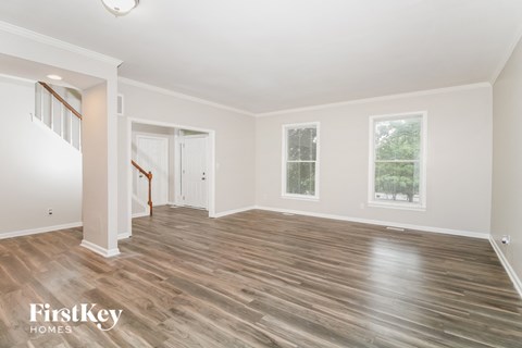 the living room with hardwood floors and a staircase