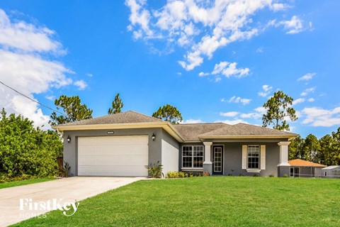 a home with a lawn and a garage