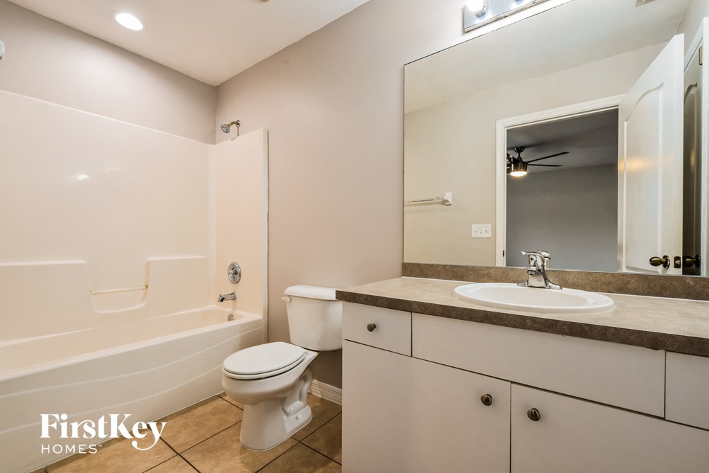 a bathroom with a sink toilet and a bath tub