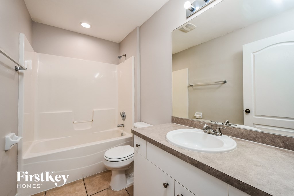 a bathroom with a sink toilet and a shower