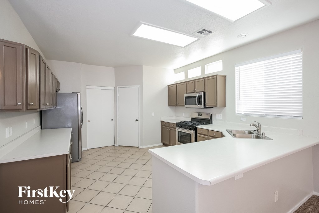 a kitchen with a white counter top and a sink