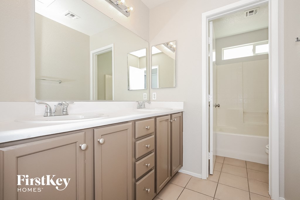 a bathroom with a sink and a mirror and a shower