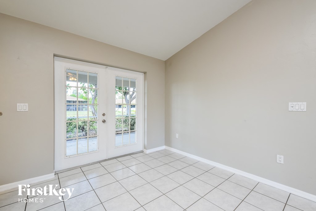 an empty living room with doors to a patio