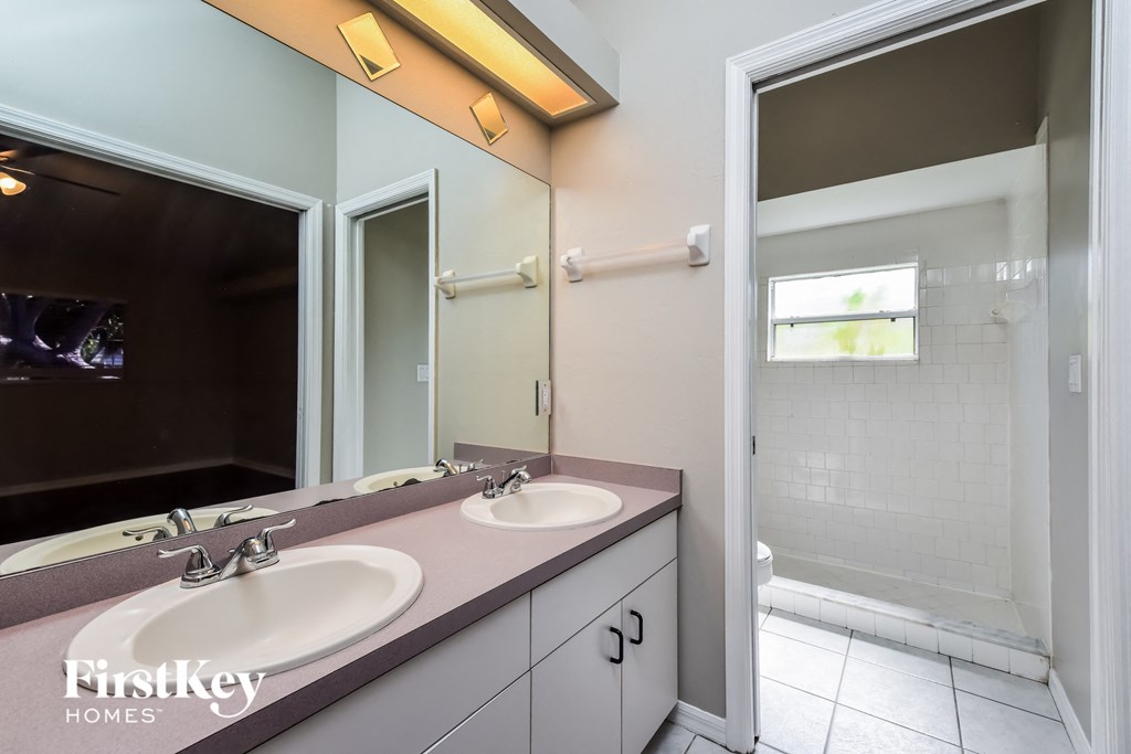 a bathroom with two sinks and a large mirror