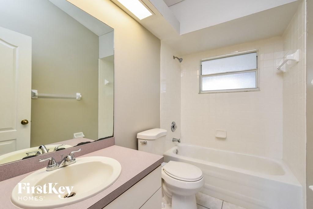 a bathroom with a sink toilet and a bath tub