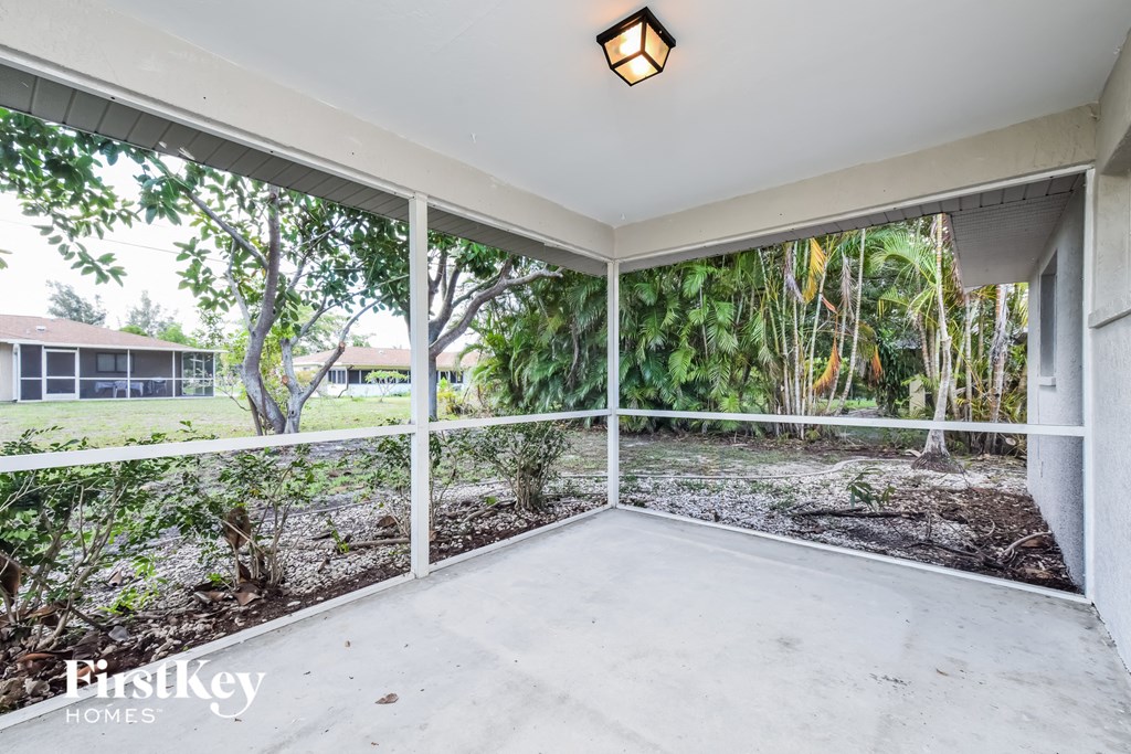 a large porch with a view of the yard and a house