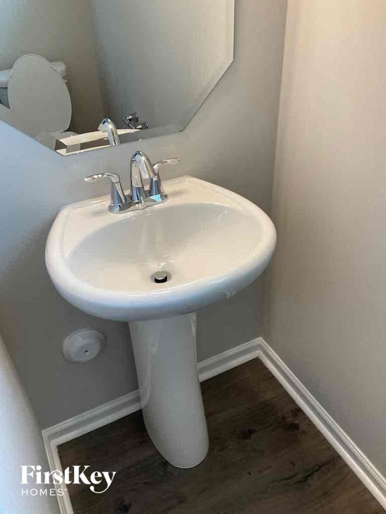a small bathroom with a sink and a mirror